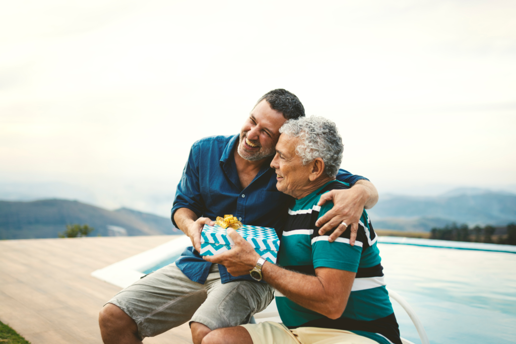 father and son on the beach exchanging Father's Day Gifts